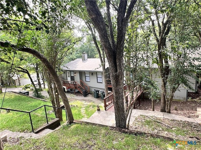 899/901 Hillyer St, San Marcos, TX 78666 - view of front of home with a front lawn and a chimney