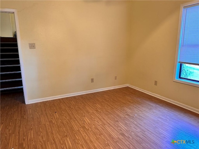 899/901 Hillyer St, San Marcos, TX 78666 - unfurnished room with dark wood-type flooring, baseboards, and stairway