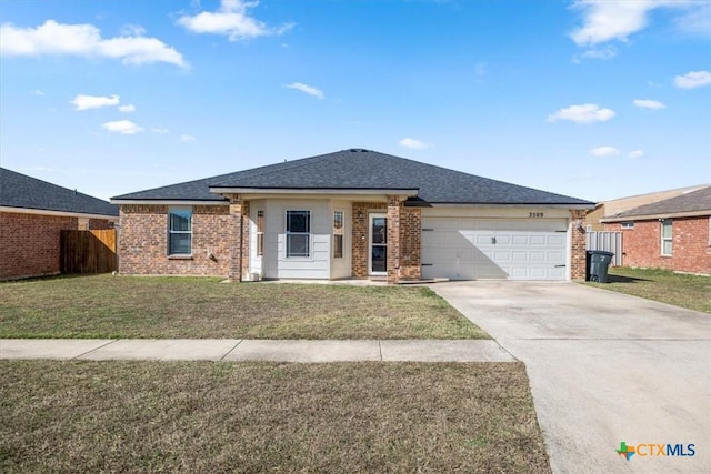 view of front of house featuring a garage and a front yard