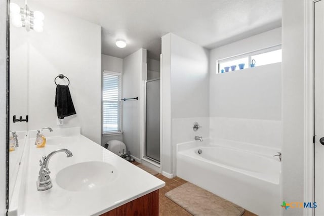 bathroom featuring vanity, tile patterned floors, a healthy amount of sunlight, and separate shower and tub