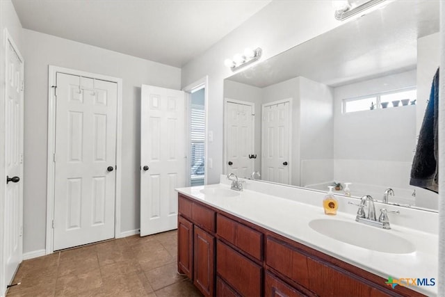 bathroom with tile patterned flooring and vanity