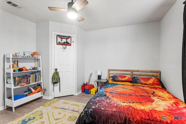 bedroom featuring hardwood / wood-style flooring and ceiling fan