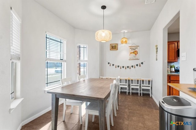 dining room with dark tile patterned floors