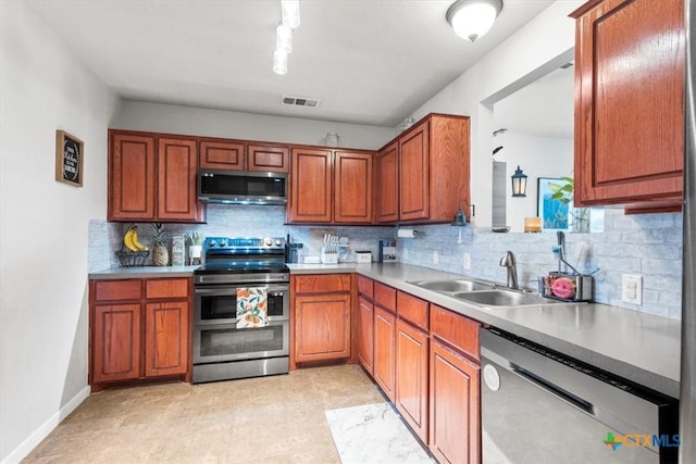 kitchen with backsplash, sink, and appliances with stainless steel finishes