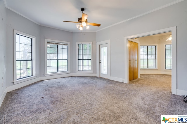 unfurnished room with light colored carpet, plenty of natural light, and ornamental molding