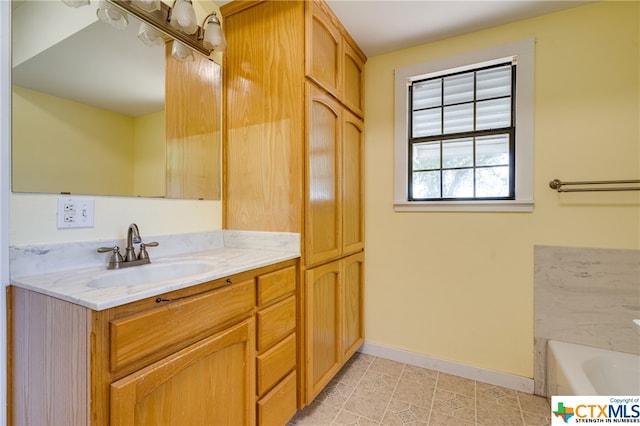 bathroom featuring vanity, tile patterned flooring, and a bathing tub