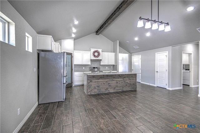 kitchen with dark wood-style floors, white cabinetry, appliances with stainless steel finishes, and backsplash