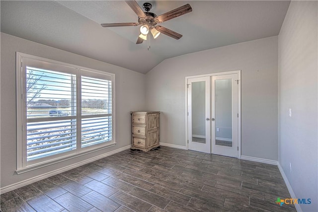 spare room with a ceiling fan, french doors, baseboards, and dark wood-style flooring