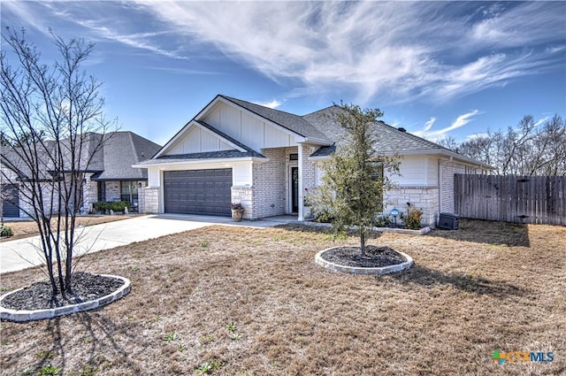 ranch-style home featuring an attached garage, board and batten siding, fence, stone siding, and driveway