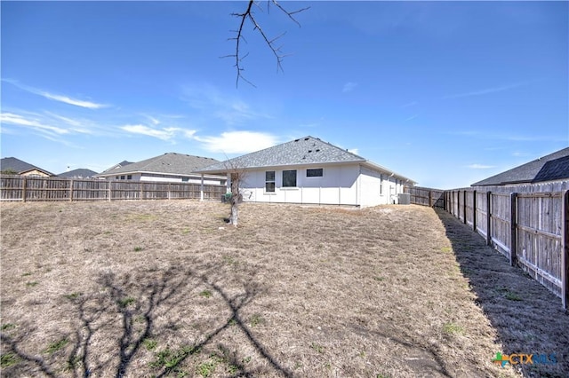 back of house with a fenced backyard