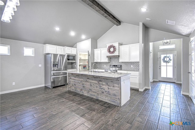 kitchen with wood finish floors, a sink, visible vents, white cabinetry, and appliances with stainless steel finishes