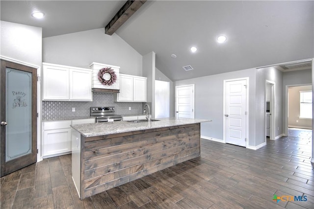 kitchen featuring electric range, visible vents, beamed ceiling, white cabinetry, and a sink