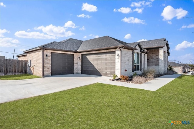 view of front of property with an attached garage, a shingled roof, fence, driveway, and a front yard