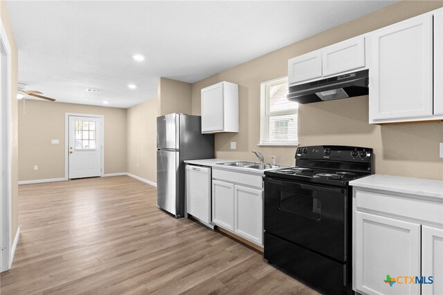 kitchen featuring electric range, dishwasher, white cabinets, and sink