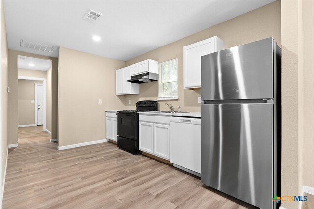 kitchen with stainless steel fridge, white dishwasher, exhaust hood, white cabinetry, and black / electric stove