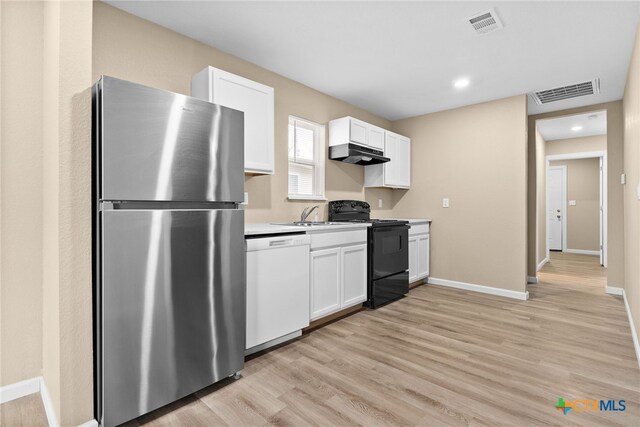 kitchen with white dishwasher, light hardwood / wood-style flooring, stainless steel fridge, black / electric stove, and white cabinetry