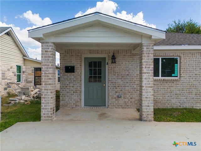 property entrance with a patio