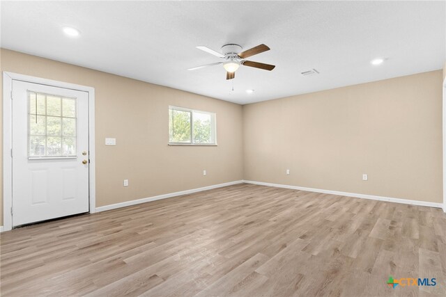 spare room with light hardwood / wood-style floors and ceiling fan