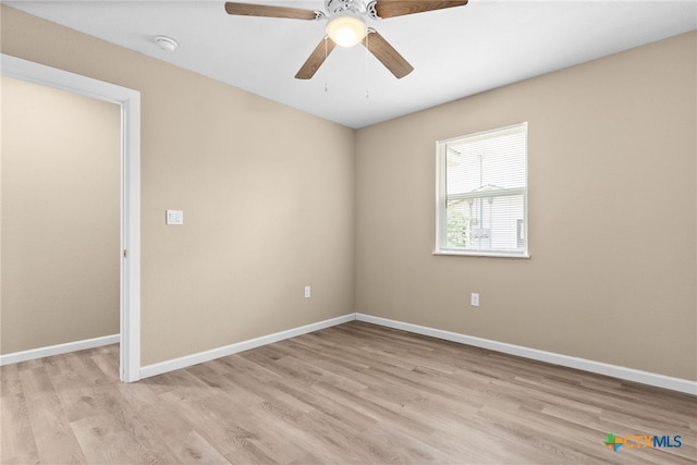 spare room featuring light hardwood / wood-style flooring and ceiling fan