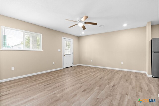 interior space with light hardwood / wood-style floors and ceiling fan