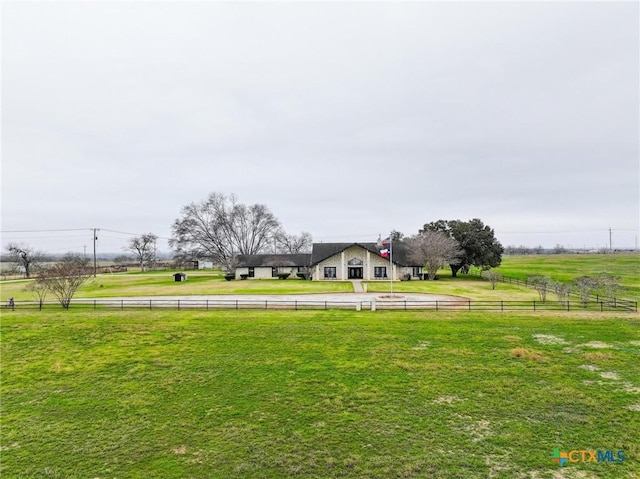 view of yard featuring a rural view and fence