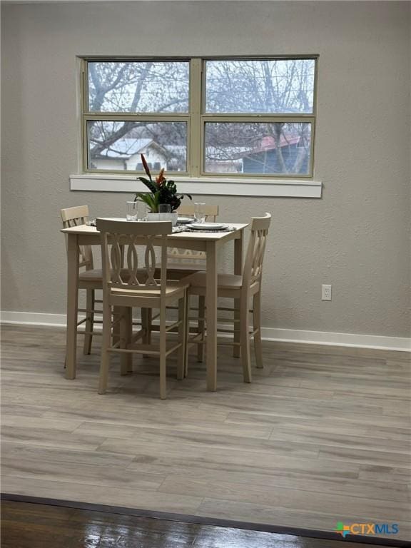 dining area featuring wood-type flooring