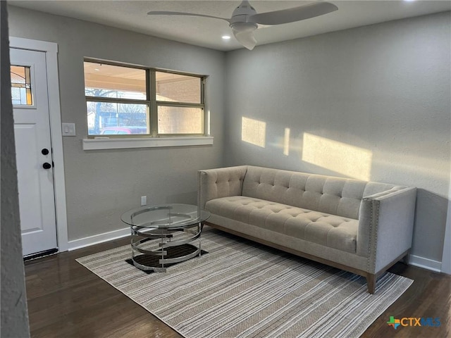 living room featuring dark hardwood / wood-style flooring and ceiling fan