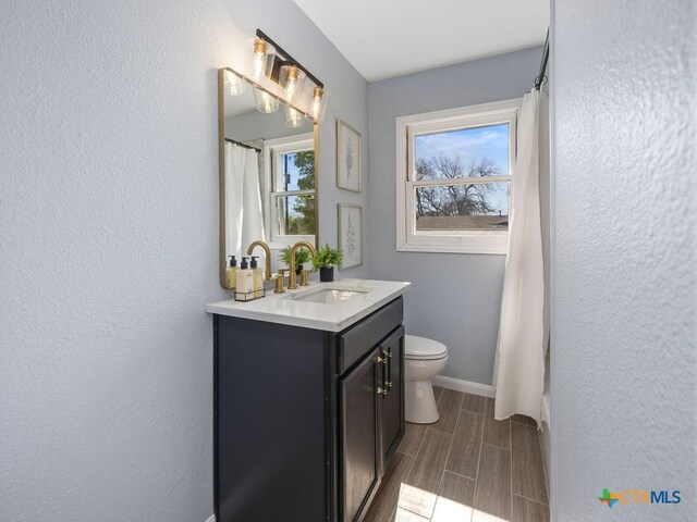 187 Meadow Ave, New Braunfels, TX 78130 - full bathroom featuring baseboards, curtained shower, toilet, and vanity