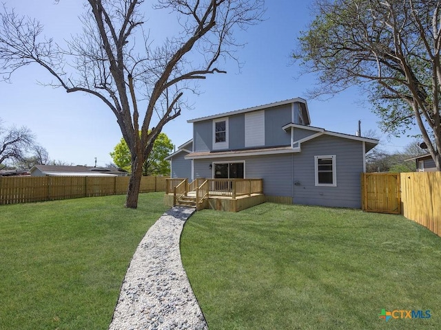 187 Meadow Ave, New Braunfels, TX 78130 - back of property with a fenced backyard, a deck, and a yard