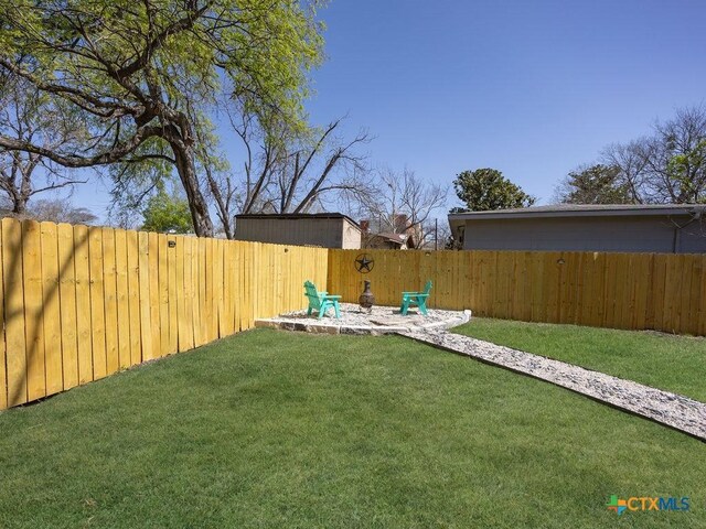 187 Meadow Ave, New Braunfels, TX 78130 - view of yard with a fenced backyard and a fire pit