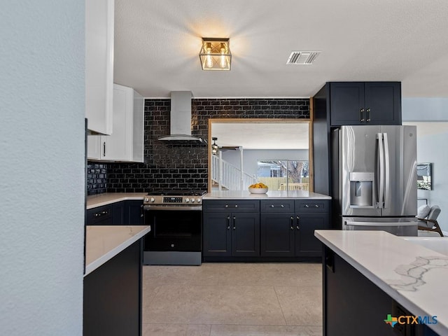187 Meadow Ave, New Braunfels, TX 78130 - kitchen with light tile patterned flooring, wall chimney exhaust hood, tasteful backsplash, stainless steel appliances, and visible vents