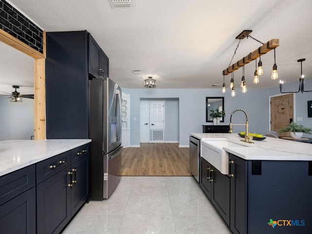 187 Meadow Ave, New Braunfels, TX 78130 - kitchen with visible vents, light stone countertops, stainless steel appliances, a ceiling fan, and a sink