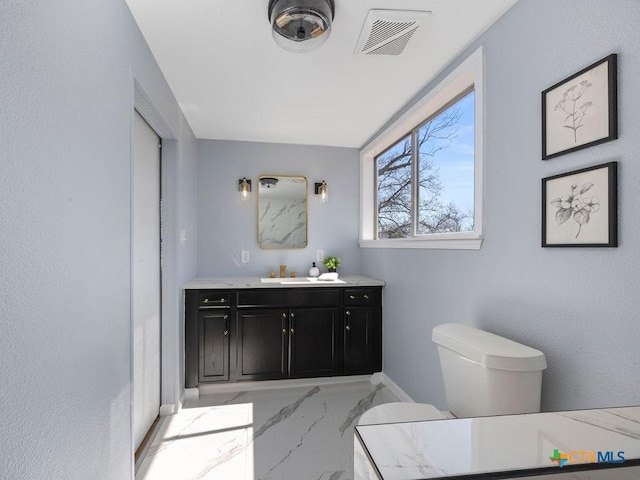 187 Meadow Ave, New Braunfels, TX 78130 - bathroom featuring marble finish floor, visible vents, toilet, and vanity