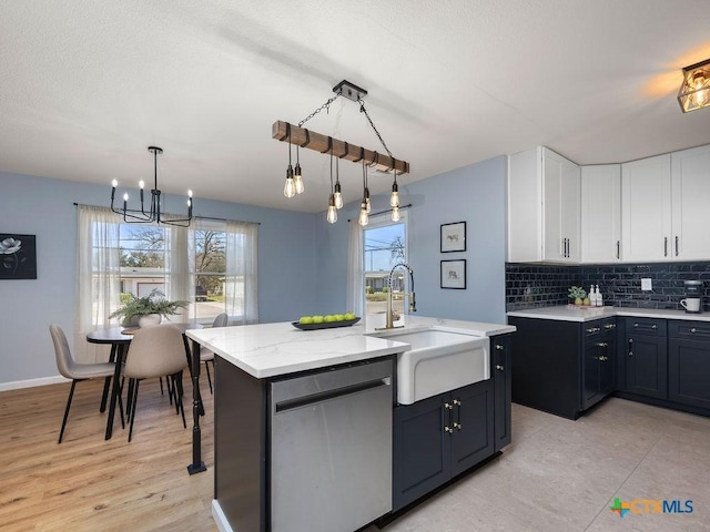 187 Meadow Ave, New Braunfels, TX 78130 - kitchen with white cabinetry, tasteful backsplash, a chandelier, stainless steel dishwasher, and a sink