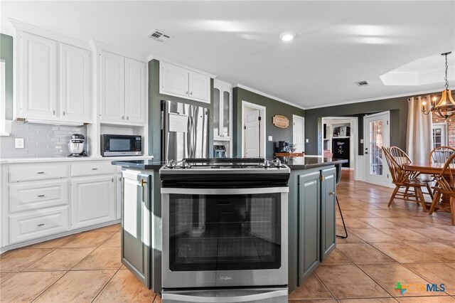 kitchen with visible vents, white cabinets, a chandelier, and stainless steel appliances