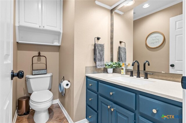 bathroom with baseboards, ornamental molding, toilet, tile patterned floors, and vanity