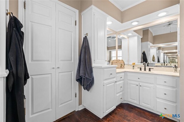 bathroom featuring vanity, a ceiling fan, wood finished floors, ornamental molding, and recessed lighting