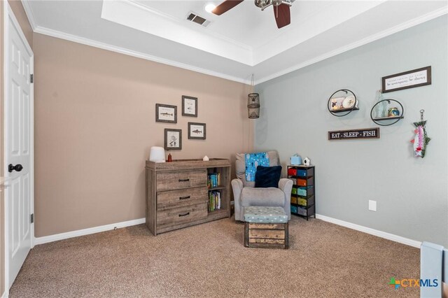 living area featuring carpet flooring, visible vents, baseboards, a ceiling fan, and a raised ceiling