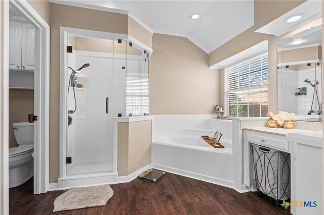 full bath with a bath, vaulted ceiling, a stall shower, and wood finished floors