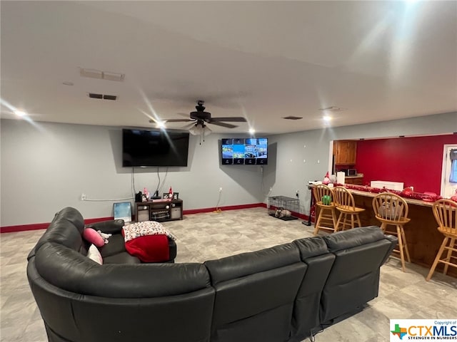 living room featuring bar area and ceiling fan