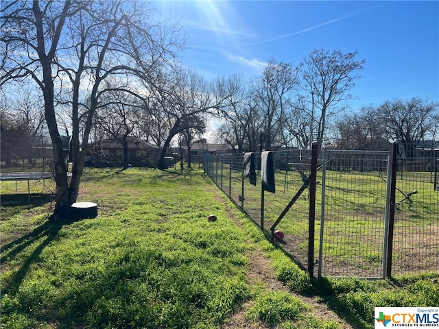 view of yard featuring a rural view and a trampoline