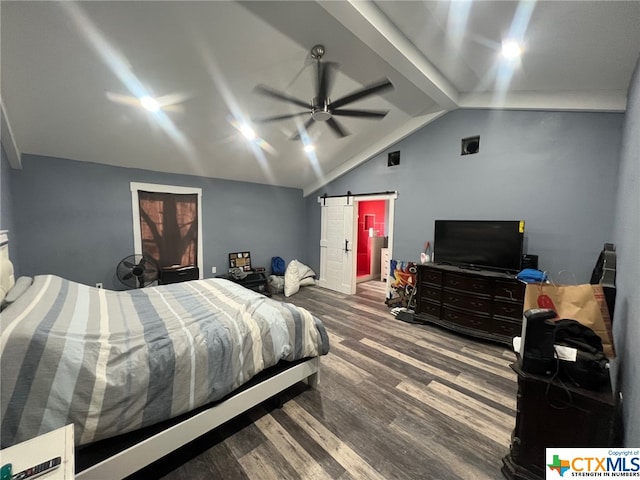 bedroom with hardwood / wood-style floors, a barn door, vaulted ceiling, and ceiling fan