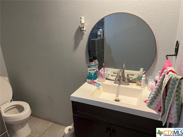 bathroom with vanity, tile patterned floors, and toilet