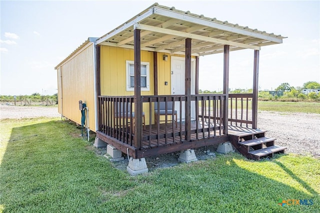 143 S Quailrun Ave, Port Lavaca, TX 77979 - back of house featuring a lawn and a wooden deck