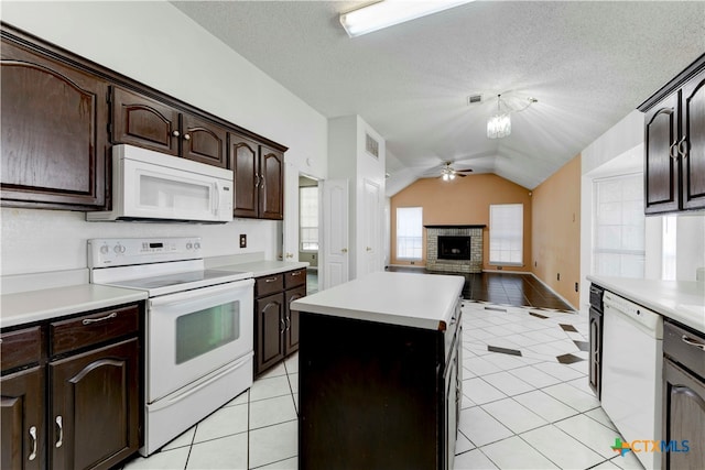 kitchen featuring ceiling fan, white appliances, vaulted ceiling, and light tile patterned floors