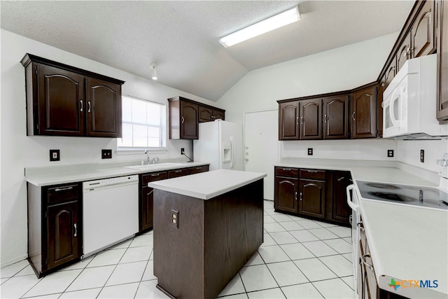 kitchen featuring dark brown cabinets, light tile patterned floors, white appliances, lofted ceiling, and a center island