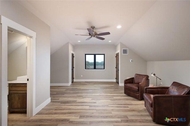 living area featuring ceiling fan, lofted ceiling, and light hardwood / wood-style floors