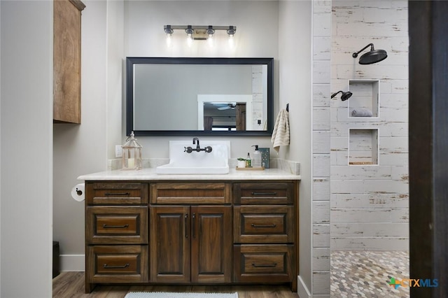 bathroom featuring vanity, hardwood / wood-style floors, and walk in shower