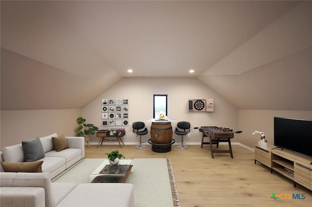 living room featuring lofted ceiling and light wood-type flooring