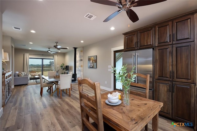 dining area with hardwood / wood-style floors and ceiling fan